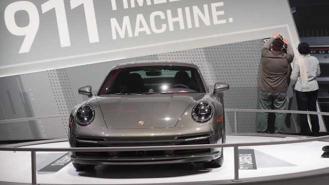 CHICAGO, ILLINOIS - FEBRUARY 06: Workers prepare a Porsche 911 Carrera S display for the opening of the Chicago Auto Show on February 06, 2019 in Chicago, Illinois. The show, which covers more than 1 million square feet of exhibit space, is the largest auto show in North America. The show is open to the public from February 9-18.  (Photo by Scott Olson/Getty Images)