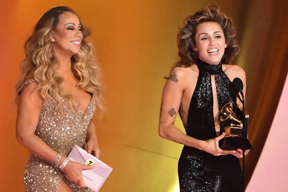 Miley Cyrus (R) accepts the Best Pop Solo Performance award for "Flowers" from Mariah Carey onstage during the 66th GRAMMY Awards at Crypto.com Arena on February 04, 2024 in Los Angeles, California.