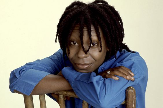 American actress Whoopi Goldberg poses for a portrait sitting in a chair in Los Angeles, California, March 1986
